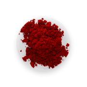 A pile of vibrant red powder of astaxathin, likely cosmetic or pigment powder, displayed on a small white plate against a solid white background.