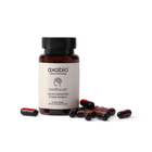 A bottle of axabio Axafocus dietary supplement capsules with several red and black capsules scattered in front, set against a solid white background.