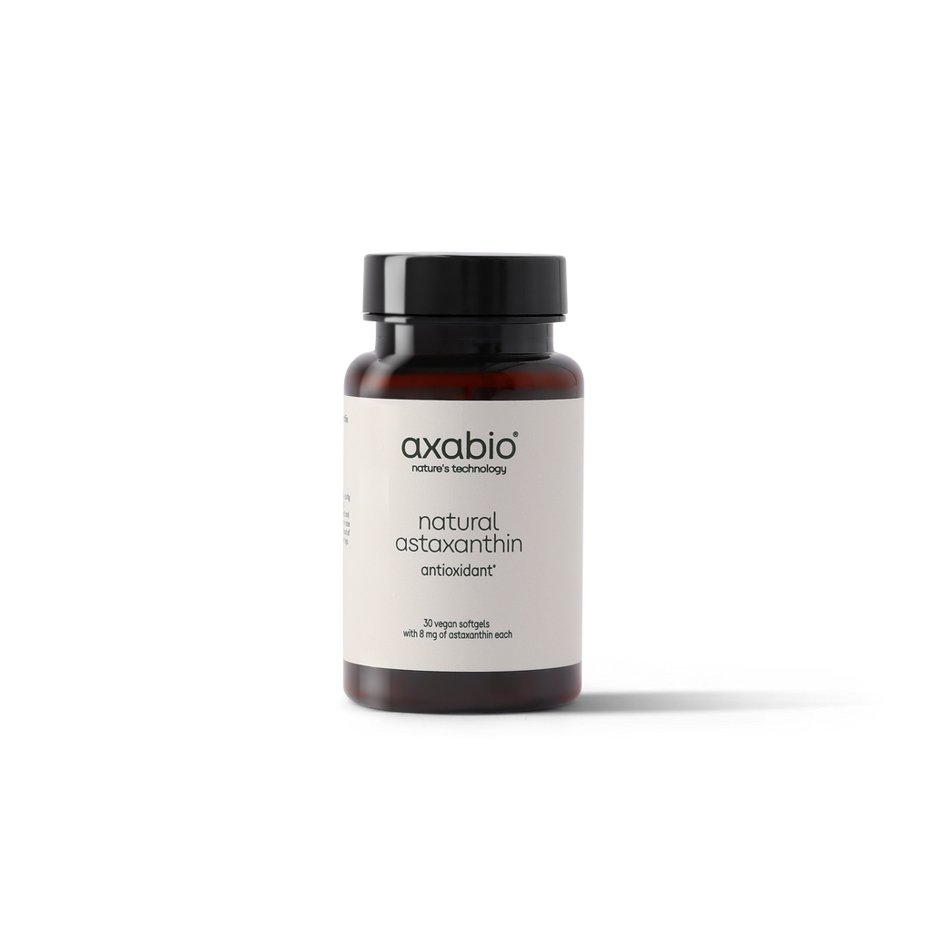 A single amber glass supplement bottle with a black cap and a white label reading 'axabio' and 'natural astaxanthin' on a clean white background.