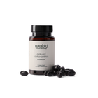 A bottle of axabio natural astaxanthin dietary supplement with a black cap and white label, shown on a white background with several dark astaxanthin crystals in front of the bottle.