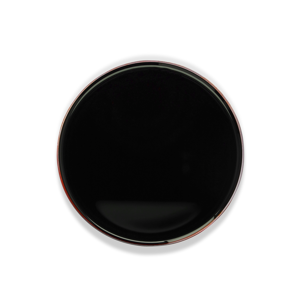 A round black plate or shallow dish viewed from directly above on a plain white background.