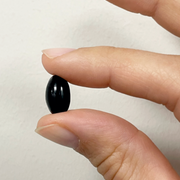 axacaps, natural astaxanthin in softgel vegan between finger