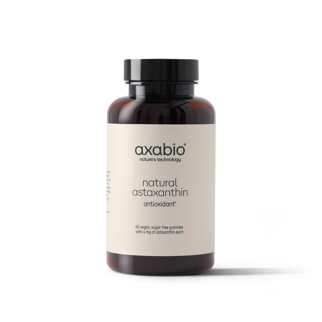 A bottle of axabio natural astaxanthin antioxidant supplement, featuring an amber glass bottle with a black cap and a cream-colored label, set against a plain white background.