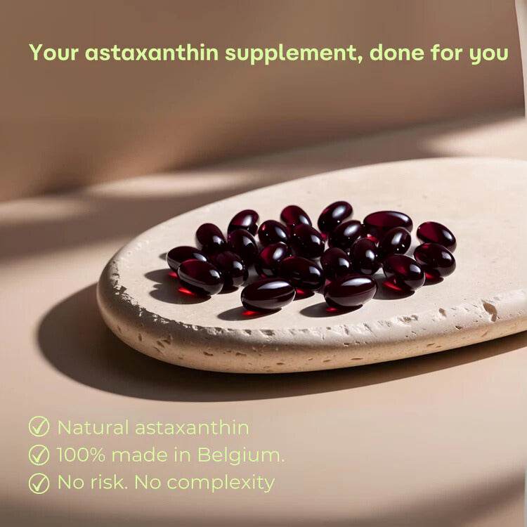 Red astaxanthin supplement vegan softgel capsules on a stone board with promotional text.